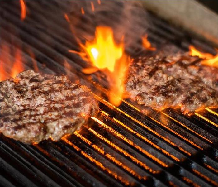 burgers over open flame grill